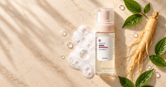 alt="SSUNSU Cera Ginseng Cloud Cleanser bottle on a flat-lay skincare background comparing foaming lather with fresh ginseng leaves, illustrating Korean face wash vs Indian face wash"